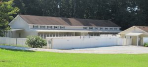 Smith Farms Kennels building with surrounding white picket fence